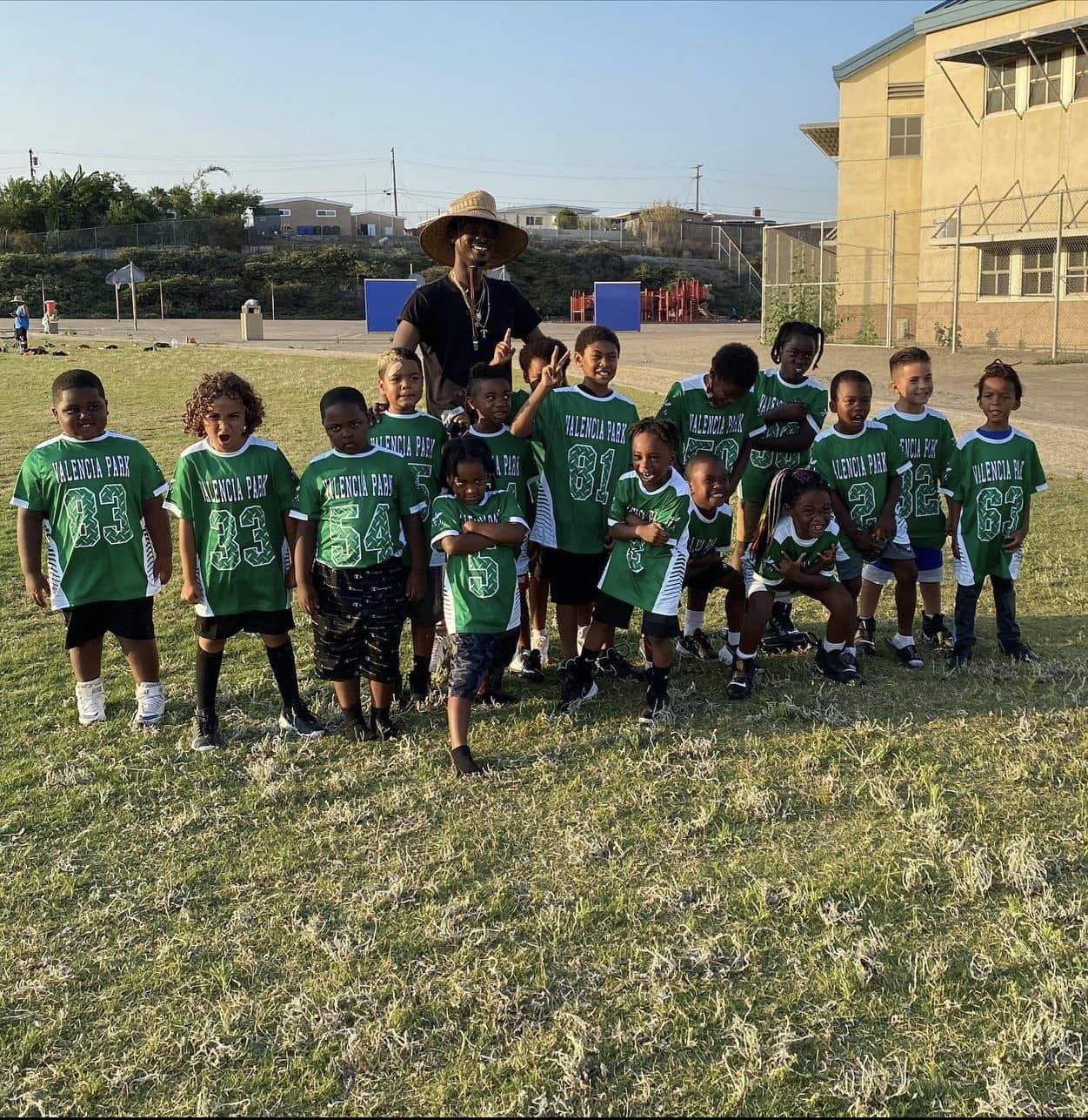 Youth football team with coach on the field