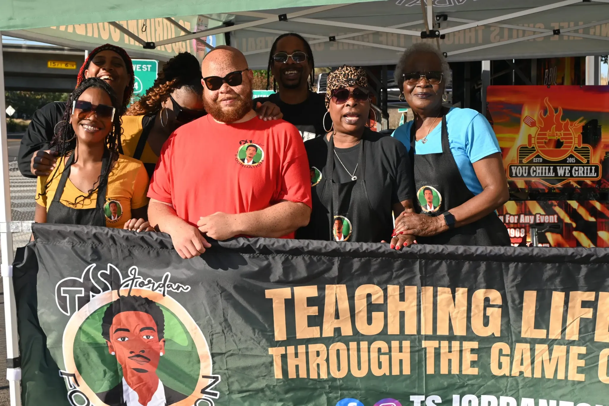 TS Jordan Foundation team serving community under event tent with banner